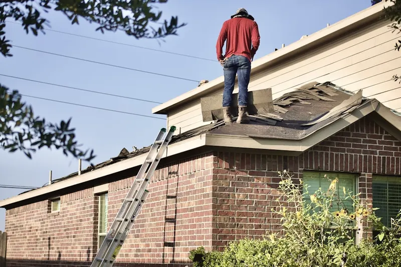 Professional roofer working on a residential roof in Fort Knox